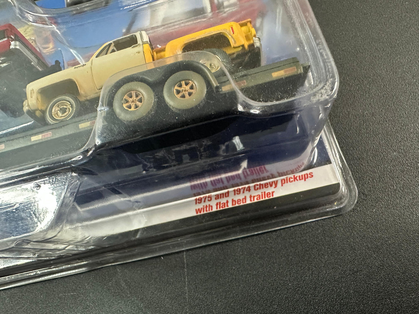 Auto World Chris Stangler CS Customs 1975 & 1974 Chevy Pickup with flatbed Trailer 1:64