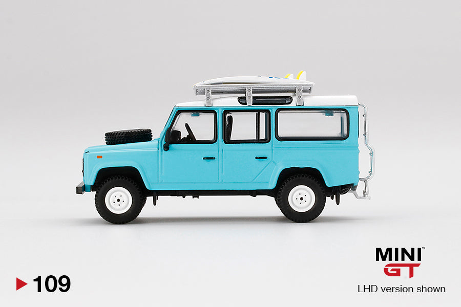Mini GT Mijo Exclusives 109 Land Rover Defender 110 Light Blue with Surfboard 1:64